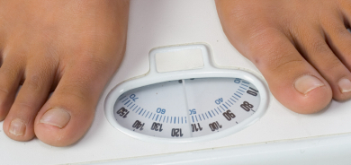 Two female feet on a bathroom scale